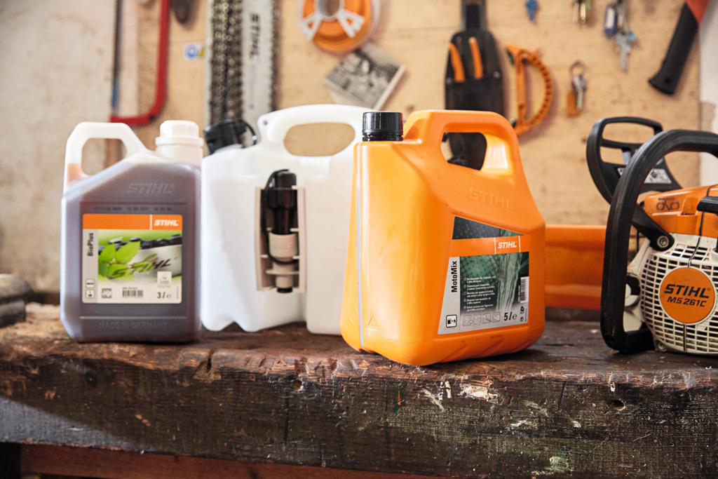 STIHL Chainsaw with fuel, engine oil and lubricant on a work bench