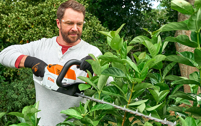 Man trimming his hedge with a STIHL Hedgetrimmer